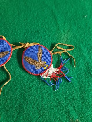 Matched pair of pictorially beaded eagle rosettes (hair ties / regalia ornaments), plate 103