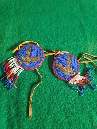 Matched pair of pictorially beaded eagle rosettes (hair ties / regalia ornaments), plate 104