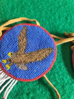 Matched pair of pictorially beaded eagle rosettes (hair ties / regalia ornaments), plate 105
