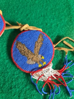 Matched pair of pictorially beaded eagle rosettes (hair ties / regalia ornaments), plate 106