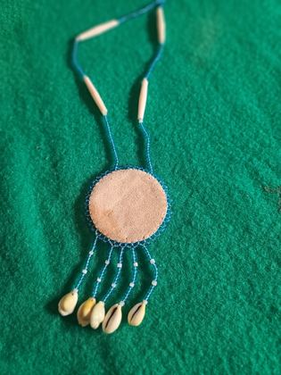 Beaded thunderbird rosette medallion necklace with bone hairpipe and cowrie shell drops, plate 111