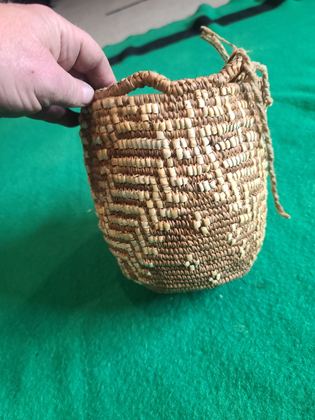 Imbricated coiled cedar-root berry basket with looped rim and buckskin ties, plate 181