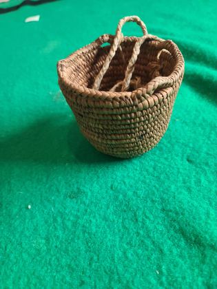 Small plain coiled cedar-root basket with cordage loops, plate 184