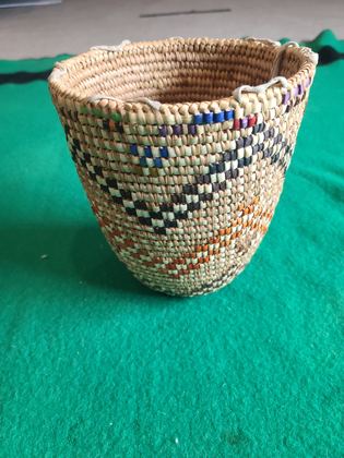 Fully imbricated coiled cedar-root berry basket with hide rim loops