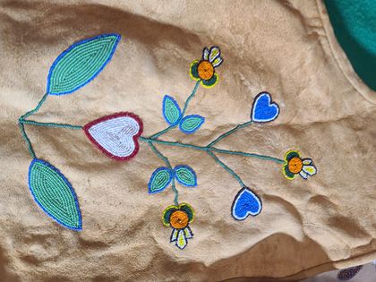 Beaded hide vest with floral sprays and a beaded yellow bird, plate 71