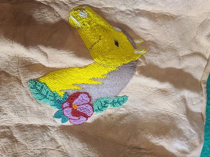 Beaded hide vest with floral sprays and a beaded yellow bird, plate 75
