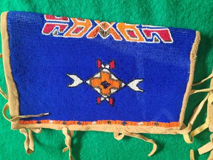 Matched pair of fully-beaded hide cuffs, cobalt field with crossed-arrow medallions, plate 78