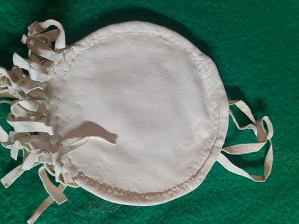 Round beaded rosette purse on white hide with fringe and tie handles, plate 88